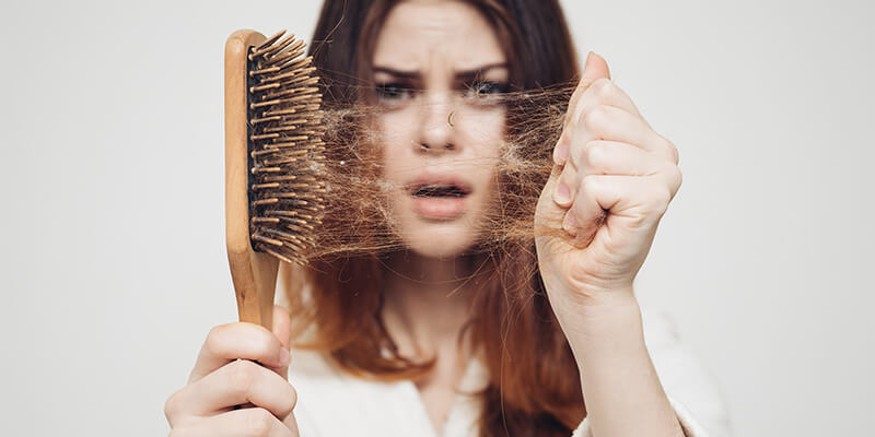 Girl Pulling Hair Out Of A Brush