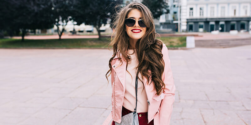girl in pink jacket with curly hair